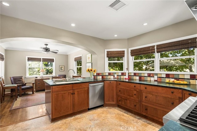 kitchen with stainless steel dishwasher, ceiling fan, sink, and kitchen peninsula