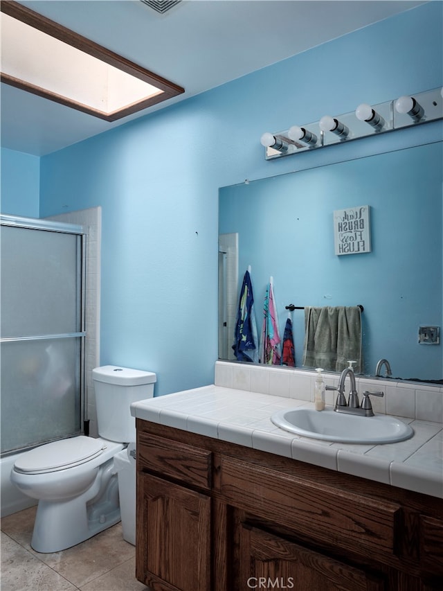 bathroom with walk in shower, vanity, toilet, and tile patterned floors