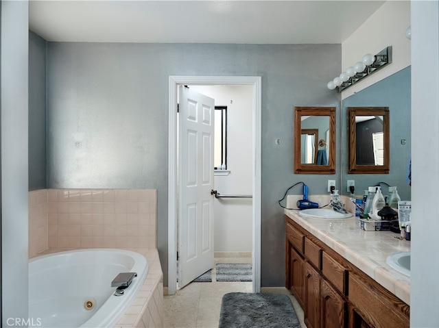 bathroom with vanity, tiled bath, and tile patterned floors