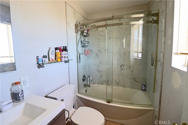 full bathroom featuring vanity, combined bath / shower with glass door, and toilet