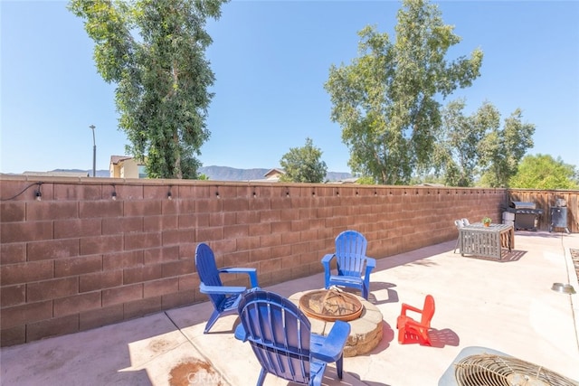 view of patio / terrace featuring an outdoor fire pit