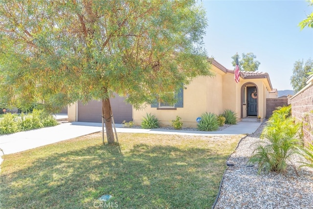 view of front of house with a front lawn and a garage