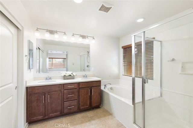 bathroom with tile patterned floors, vanity, and separate shower and tub