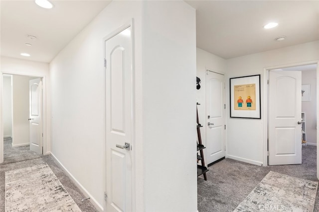 hallway with light colored carpet