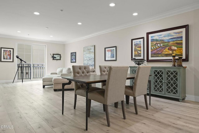 dining area featuring light hardwood / wood-style flooring and ornamental molding