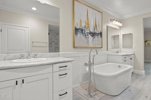 bathroom with ornamental molding, hardwood / wood-style flooring, vanity, and shower with separate bathtub