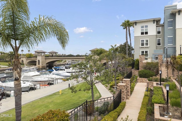 surrounding community featuring a water view and a lawn