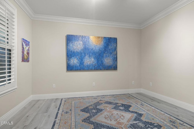 unfurnished room featuring light wood-type flooring and ornamental molding