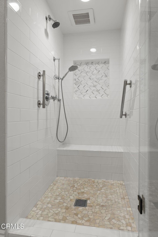 bathroom with a tile shower