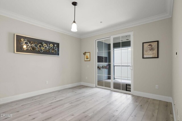 unfurnished room featuring light wood-type flooring and crown molding