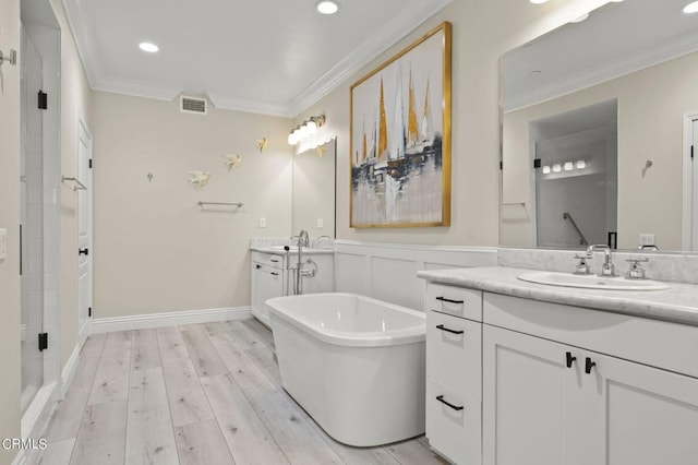 bathroom with hardwood / wood-style flooring, crown molding, vanity, and independent shower and bath