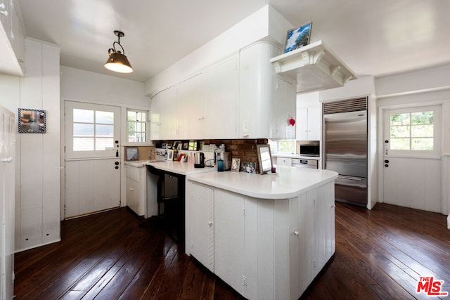 kitchen with a healthy amount of sunlight, dark hardwood / wood-style flooring, and stainless steel built in refrigerator