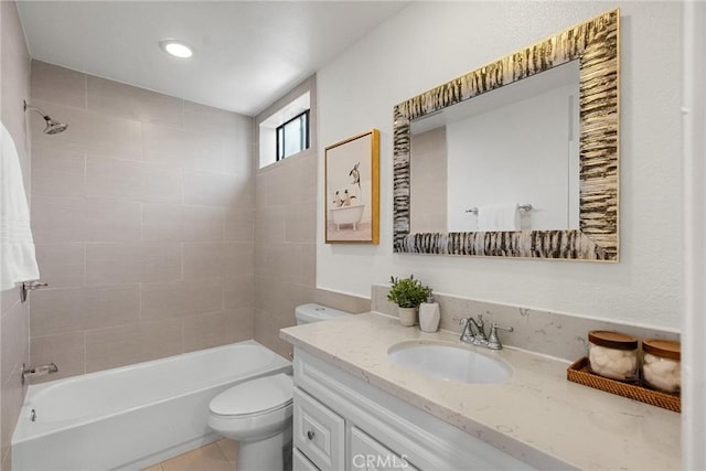 full bathroom featuring toilet, vanity, and tiled shower / bath