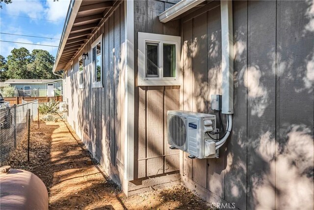 view of side of home with ac unit