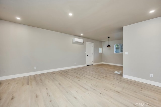 interior space featuring light hardwood / wood-style flooring and a wall unit AC