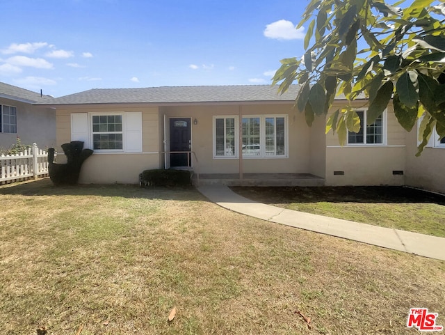 ranch-style home with a front lawn