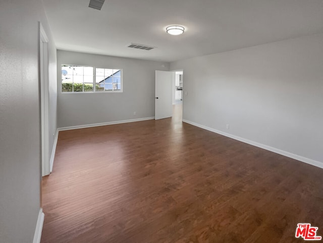 empty room with dark wood-type flooring