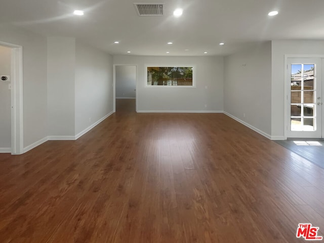 spare room with dark wood-type flooring