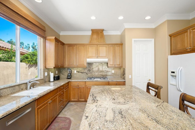 kitchen featuring light stone countertops, sink, stainless steel appliances, and plenty of natural light