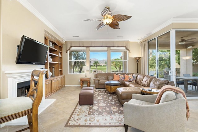 living room featuring ceiling fan, light tile patterned floors, and crown molding