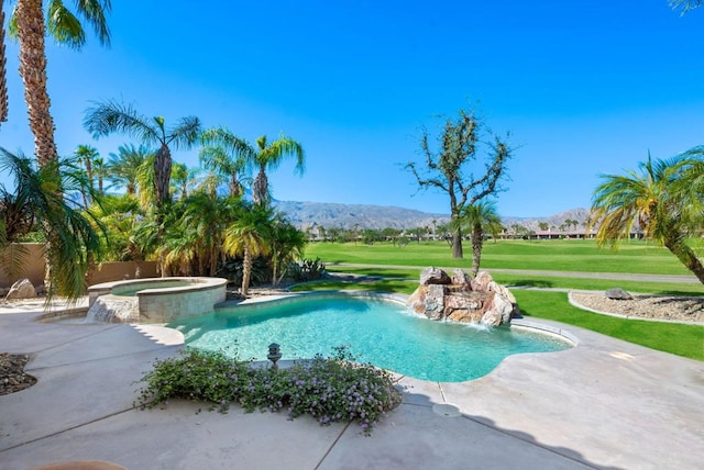 view of swimming pool featuring a mountain view, a yard, an in ground hot tub, and pool water feature