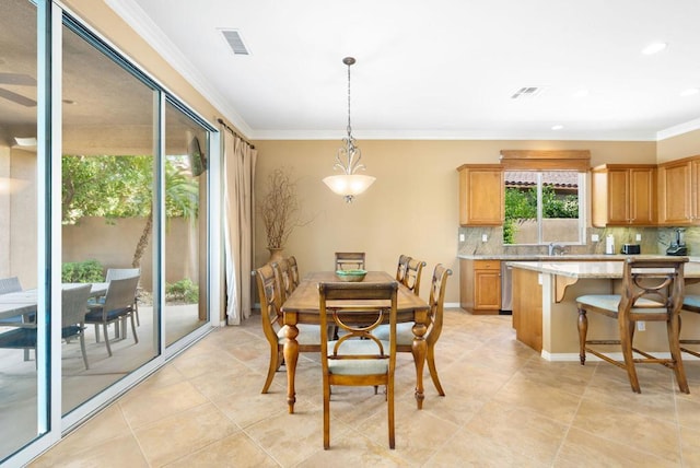 tiled dining space featuring crown molding