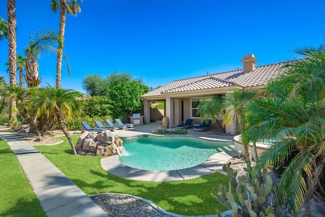 view of swimming pool with a lawn and a patio area