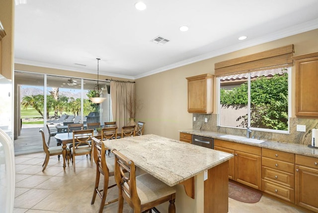 kitchen with dishwasher, light stone counters, decorative light fixtures, and tasteful backsplash