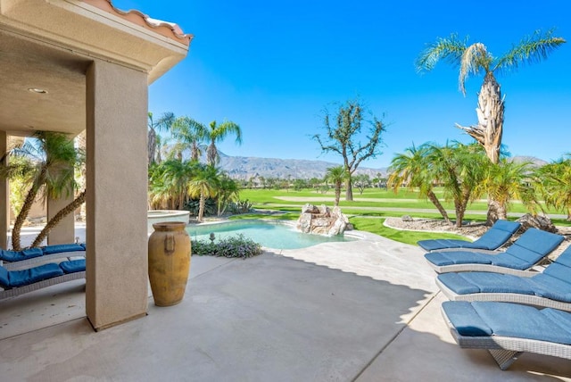 view of patio / terrace featuring a mountain view and a jacuzzi