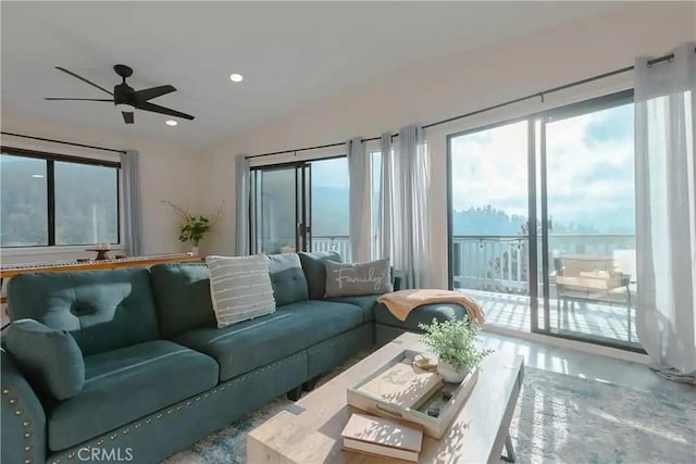 living room featuring a wealth of natural light and ceiling fan