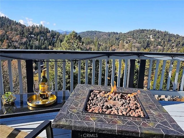 exterior space featuring a mountain view and a fire pit