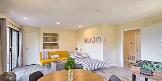 dining area featuring built in features and light wood-type flooring