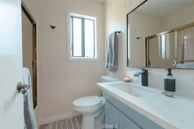 full bathroom with vanity, toilet, and bath / shower combo with glass door