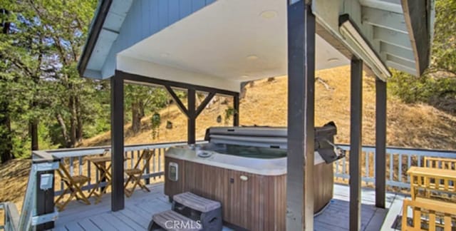 wooden terrace with a hot tub