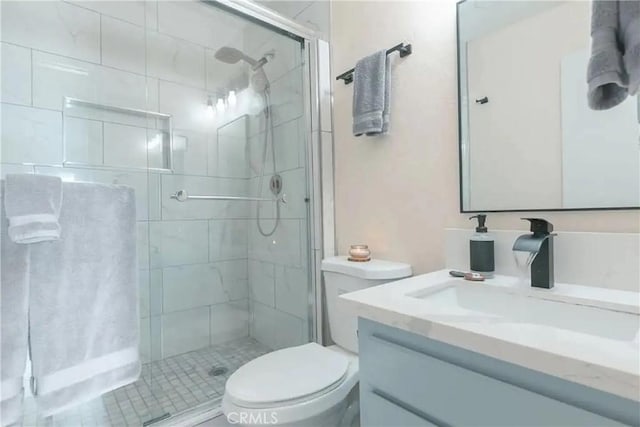 bathroom featuring vanity, toilet, and a shower with door