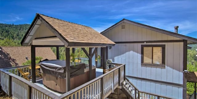 wooden terrace with a hot tub