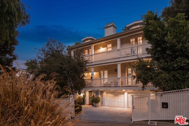 view of front of home featuring a balcony and a garage