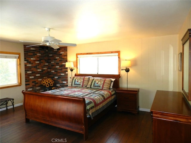 bedroom featuring ceiling fan, multiple windows, and dark hardwood / wood-style flooring