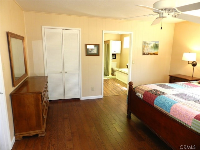 bedroom with connected bathroom, a closet, dark wood-type flooring, and ceiling fan