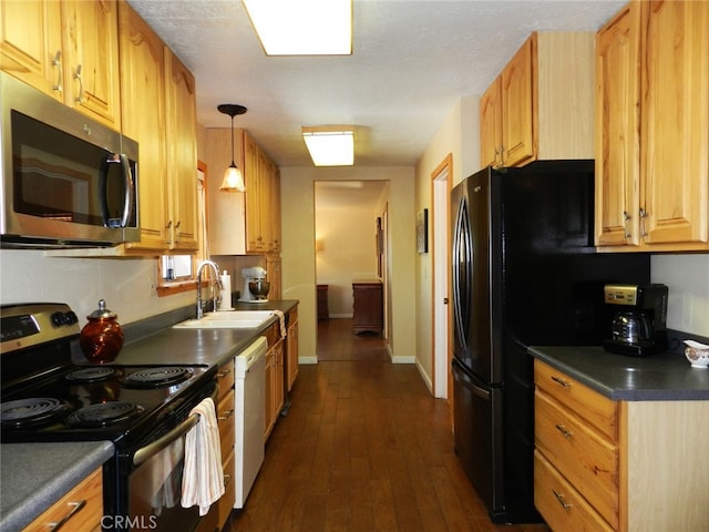 kitchen featuring hanging light fixtures, appliances with stainless steel finishes, a textured ceiling, dark wood-type flooring, and sink