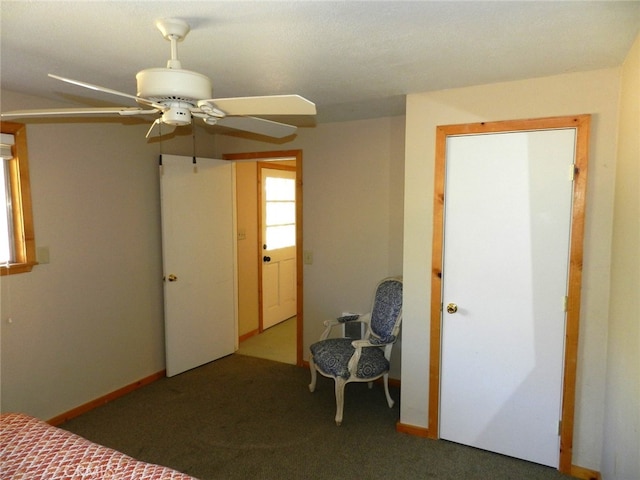 unfurnished bedroom featuring dark carpet and ceiling fan