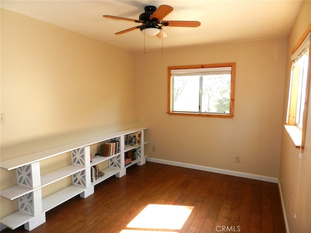 spare room featuring ceiling fan and dark hardwood / wood-style floors