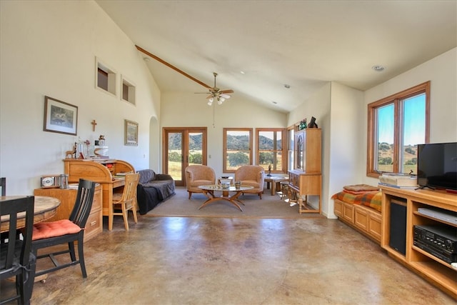 living area featuring high vaulted ceiling, arched walkways, finished concrete flooring, and a ceiling fan