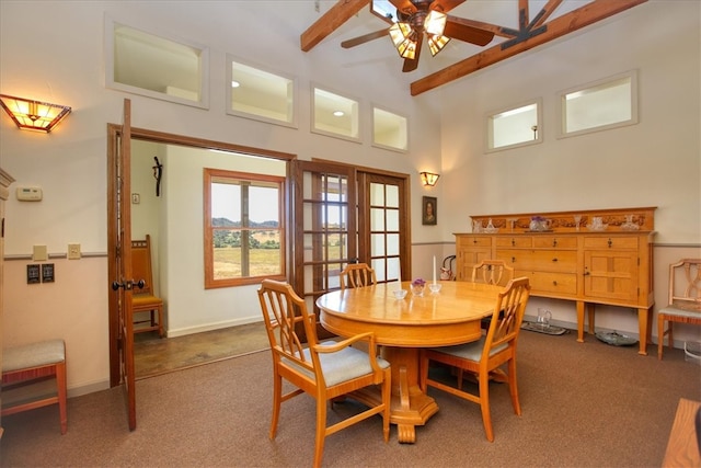 dining room with a ceiling fan, baseboards, dark colored carpet, and beamed ceiling