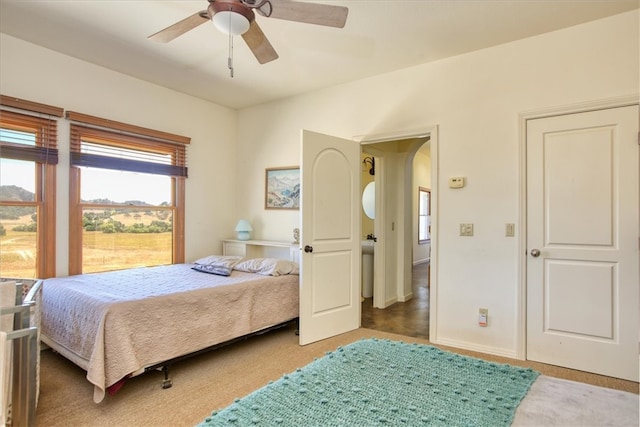 bedroom featuring ceiling fan and dark carpet