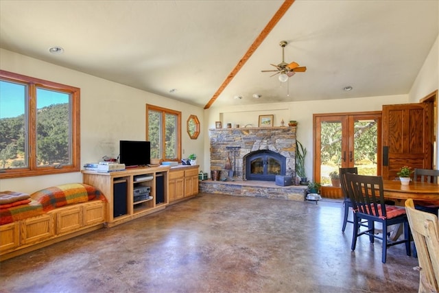 living room featuring lofted ceiling, french doors, a fireplace, and finished concrete flooring