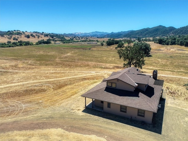 drone / aerial view with a mountain view and a rural view