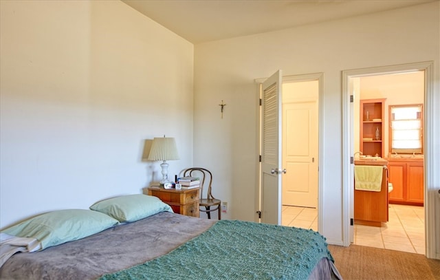 bedroom featuring light tile patterned floors and light carpet