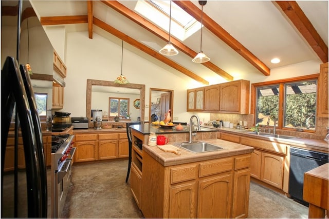 kitchen featuring a kitchen island with sink, a sink, hanging light fixtures, light countertops, and black appliances