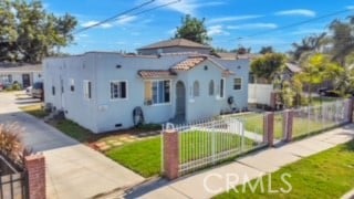 mediterranean / spanish home with a front lawn